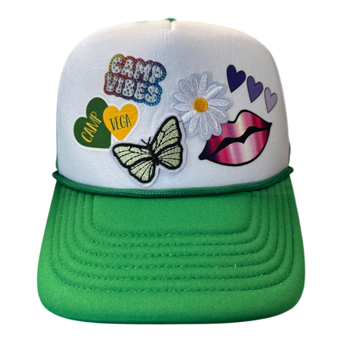 Custom camp trucker hat with white front, green brim, Camp Vibes and Camp Vega heart patches, butterfly, daisy and lips