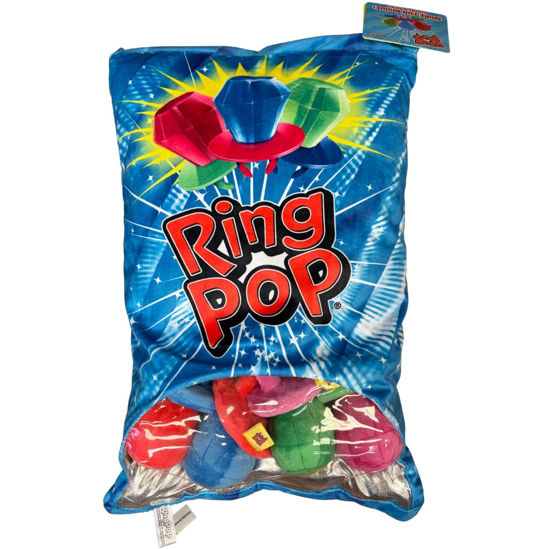 Ring Pop cherry scented plush pillow shaped like candy bag with bright blue background, red and green Ring Pop graphics, and soft stuffed fabric