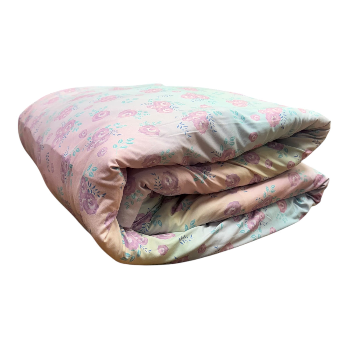 Blushing Blossoms reversible camp comforter folded to show the pink and rose floral side