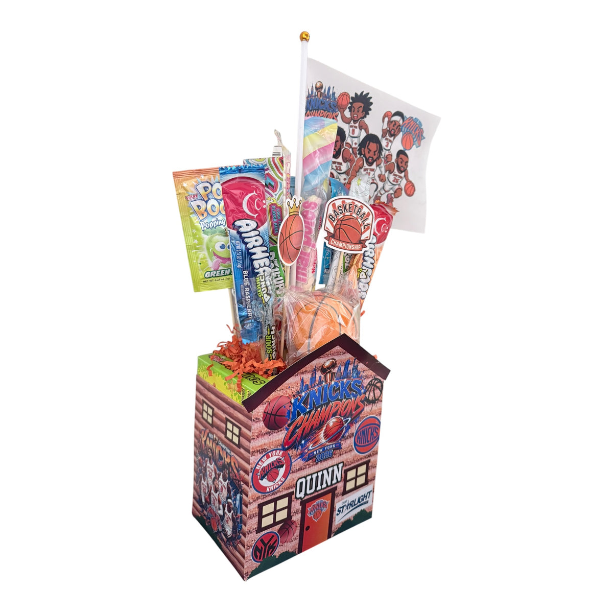 Side view of Knicks basketball themed candy cabin showing Quinn name, candy sticks, basketball decorations and colorful wrapped candies