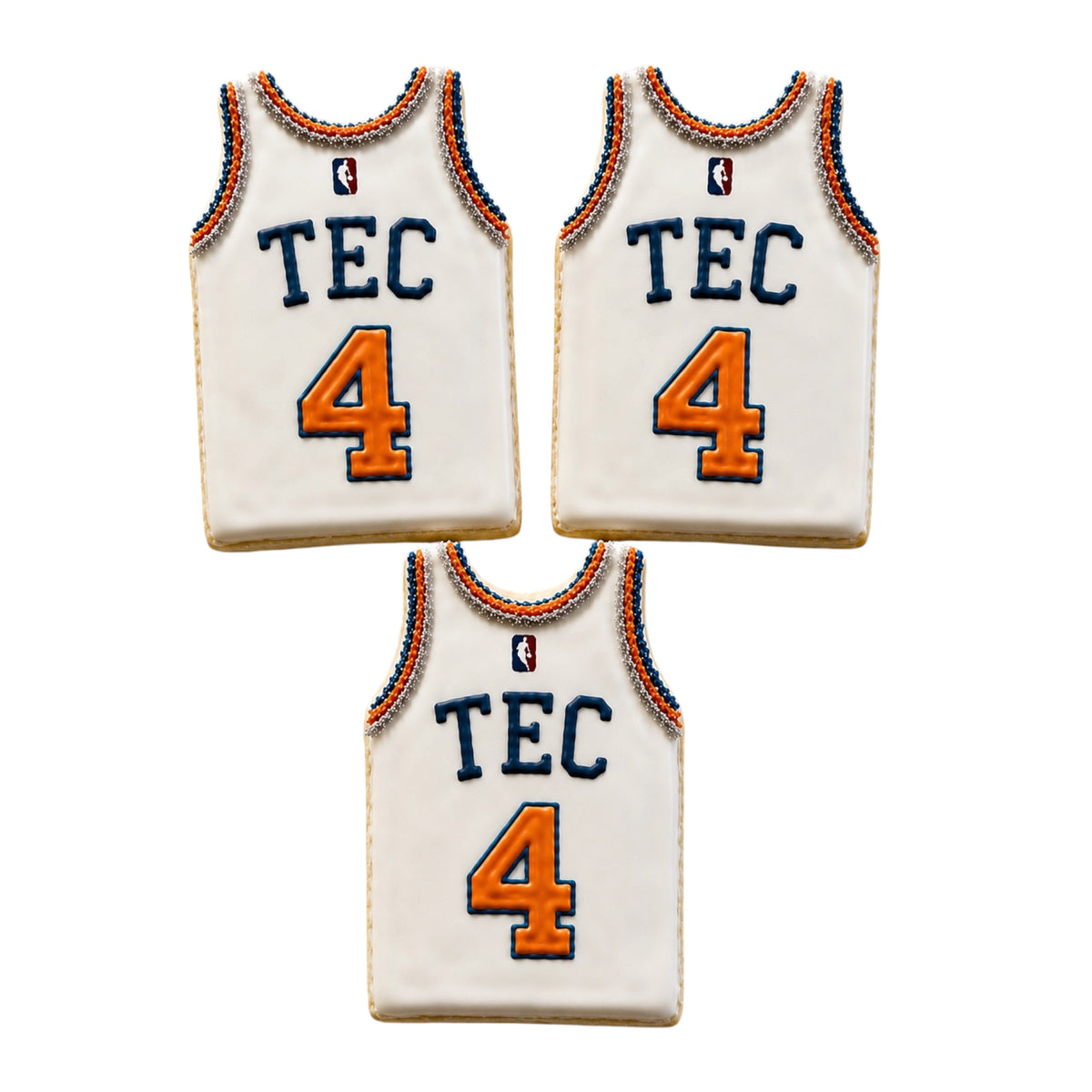 Three custom Knicks basketball jersey cookies in white with blue TEC letters, orange number 4, NBA logo, and detailed beaded trim decoration