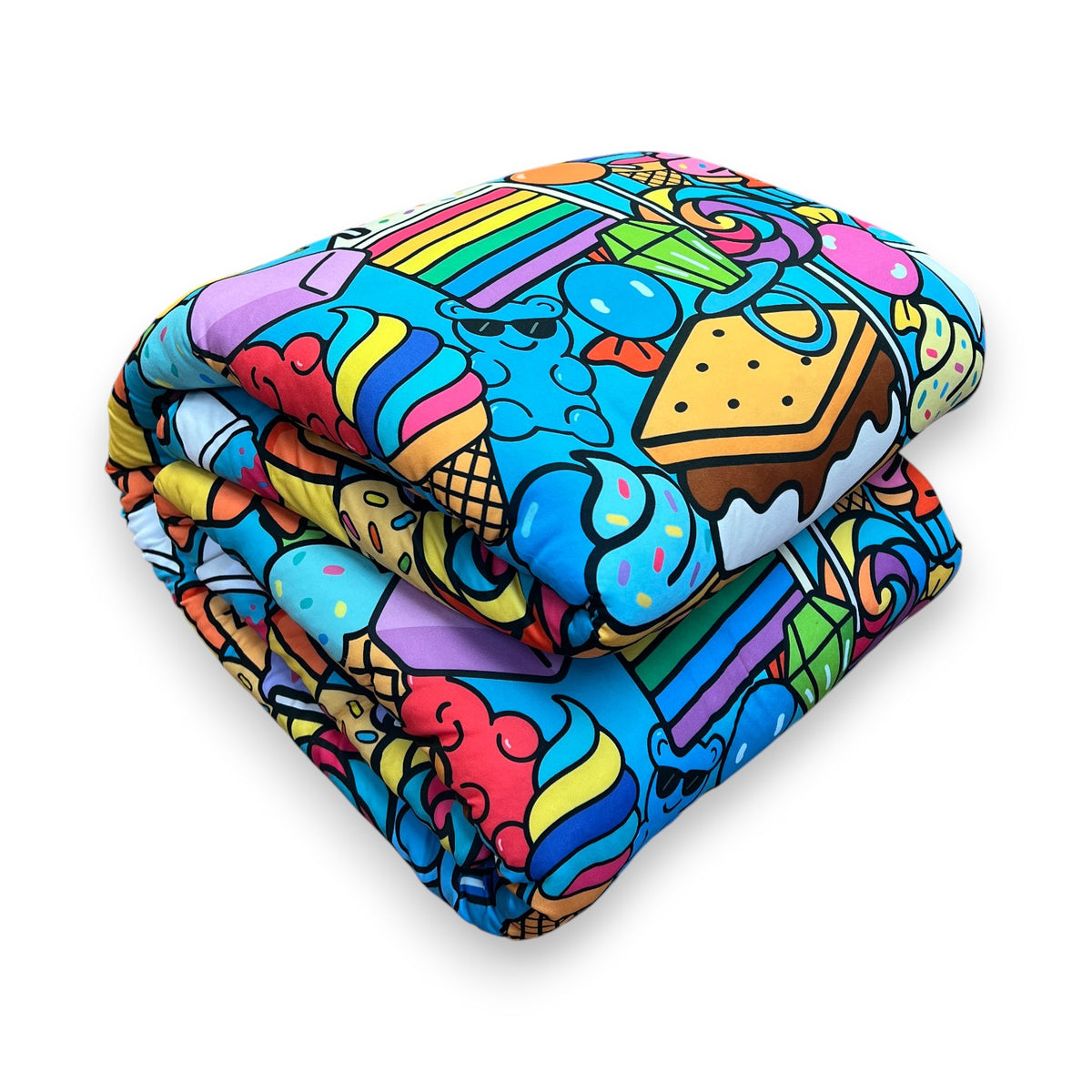 Folded Let Me See You Tootsie Roll reversible camp comforter in a bright candy doodle print