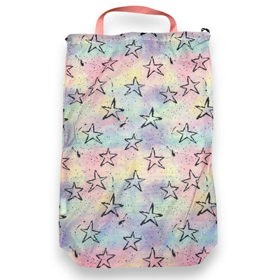 Mesh laundry bag in pastel tie-dye with black splatter stars and a pink handle