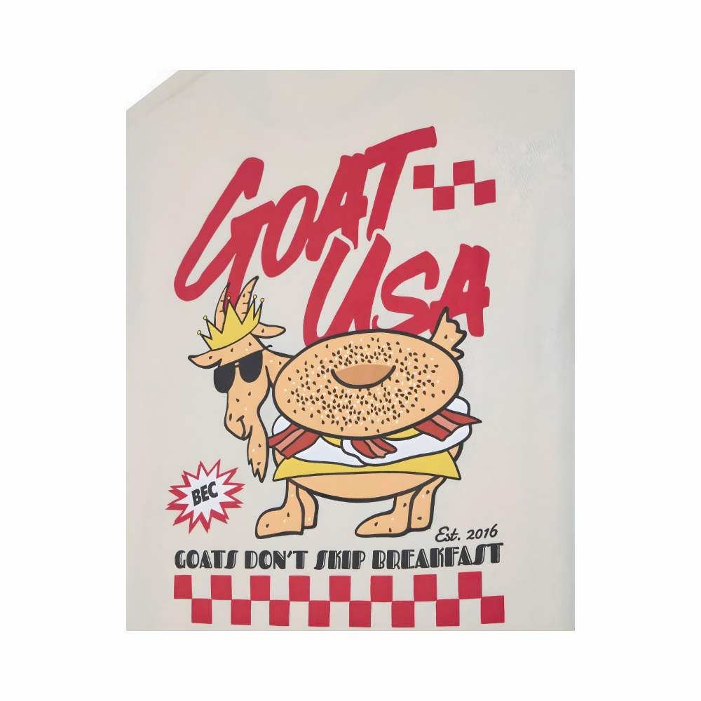 Close-up of GOAT USA breakfast t-shirt back design with goat in crown, bagel body, and checkered pattern details on cream tee
