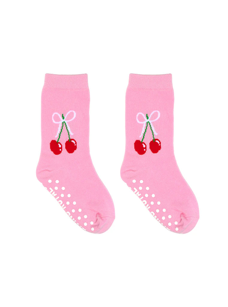 Pair of pink grip socks with red cherries and a white bow