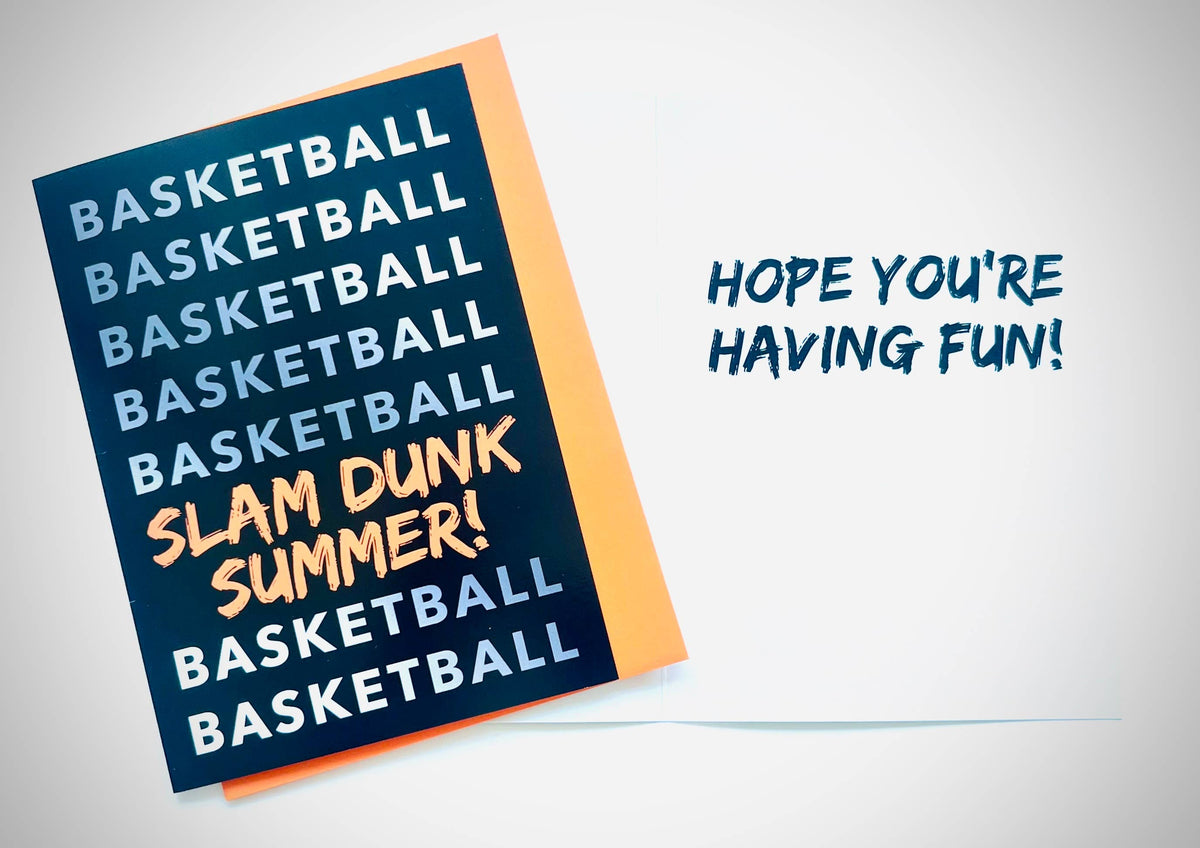 Navy blue basketball greeting card with repeated BASKETBALL text and orange SLAM DUNK SUMMER lettering, displayed on gray background with 'Hope you're having fun!' text