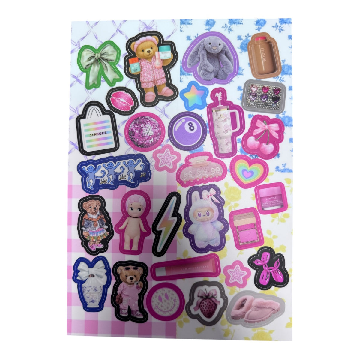 Positively Preppy sticker sheet with colorful preppy designs including teddy bears in pink outfits, gray bunny plush, disco ball, rainbow hearts, bows, beauty products, Sephora bag, lightning bolt, and slippers on checkered background