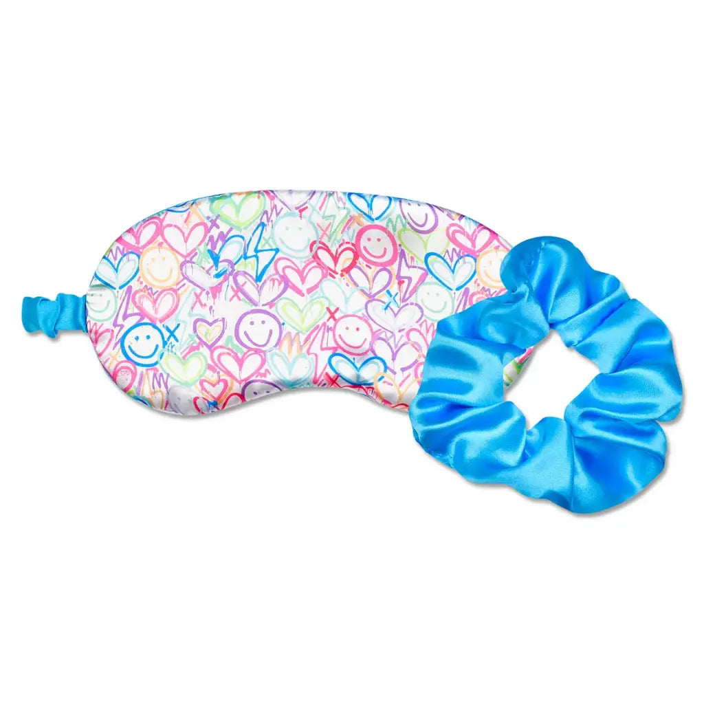 Corey Paige eye mask with pastel graffiti hearts and smileys, with a matching bright blue satin scrunchie
