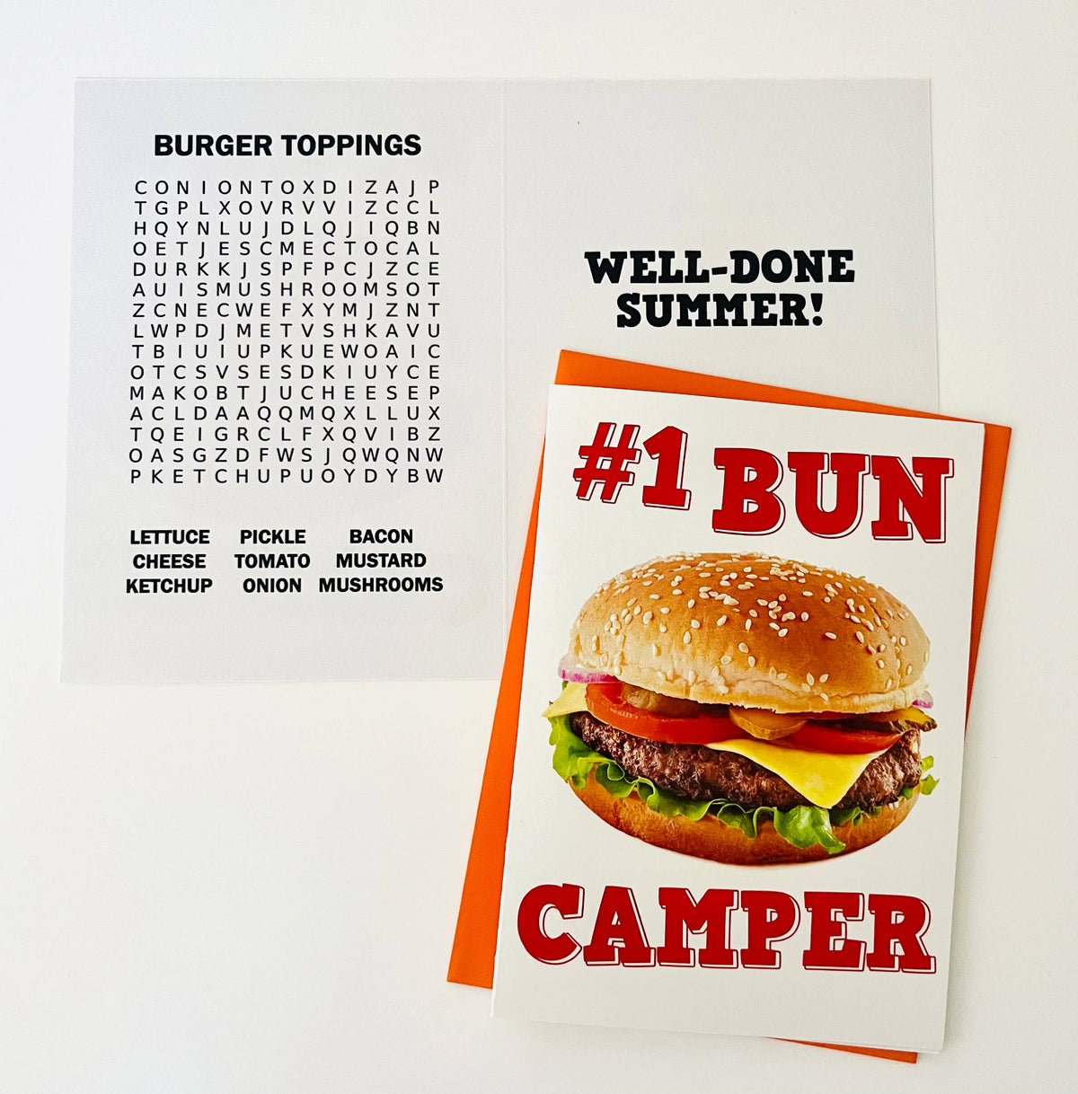 Burger toppings word search puzzle on white background showing grid with words like lettuce, pickle, bacon, cheese, tomato, ketchup, onion, mustard, mushrooms to find