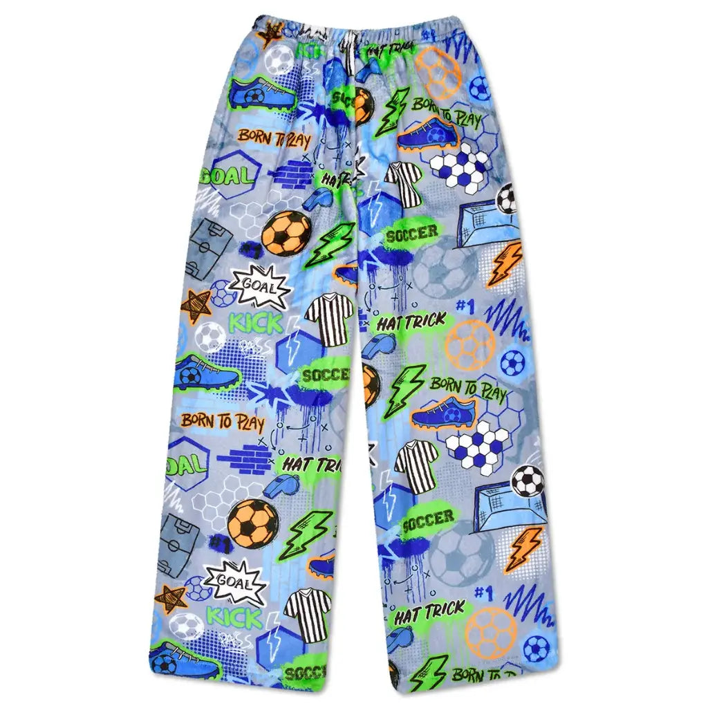 Corey Paige Born To Play Soccer plush pants in light blue tie-dye with colorful soccer graphics including cleats, jerseys, lightning bolts, soccer balls, and Born to Play text