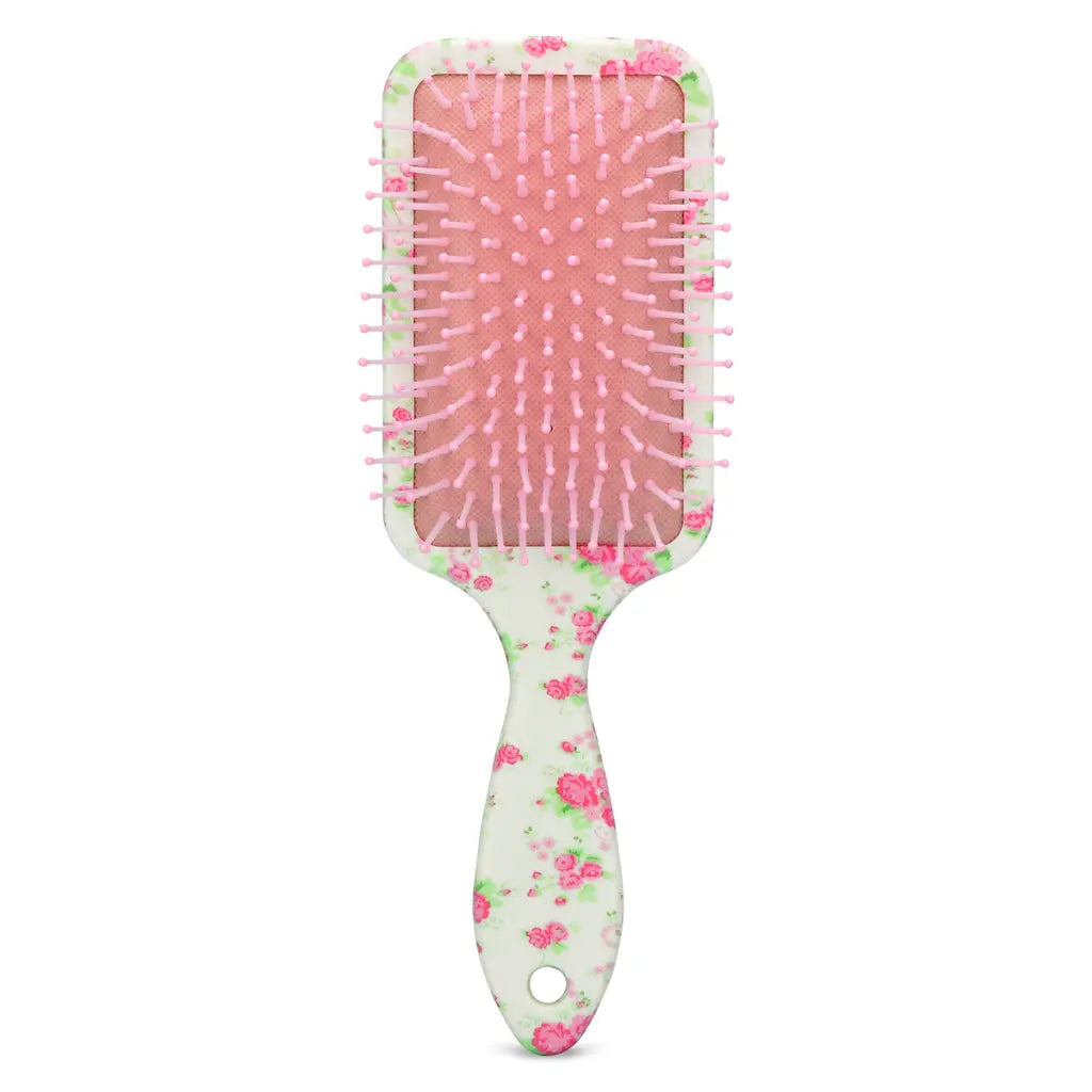 Forever Pretty paddle brush with pink bristles and a white handle with pink and green roses