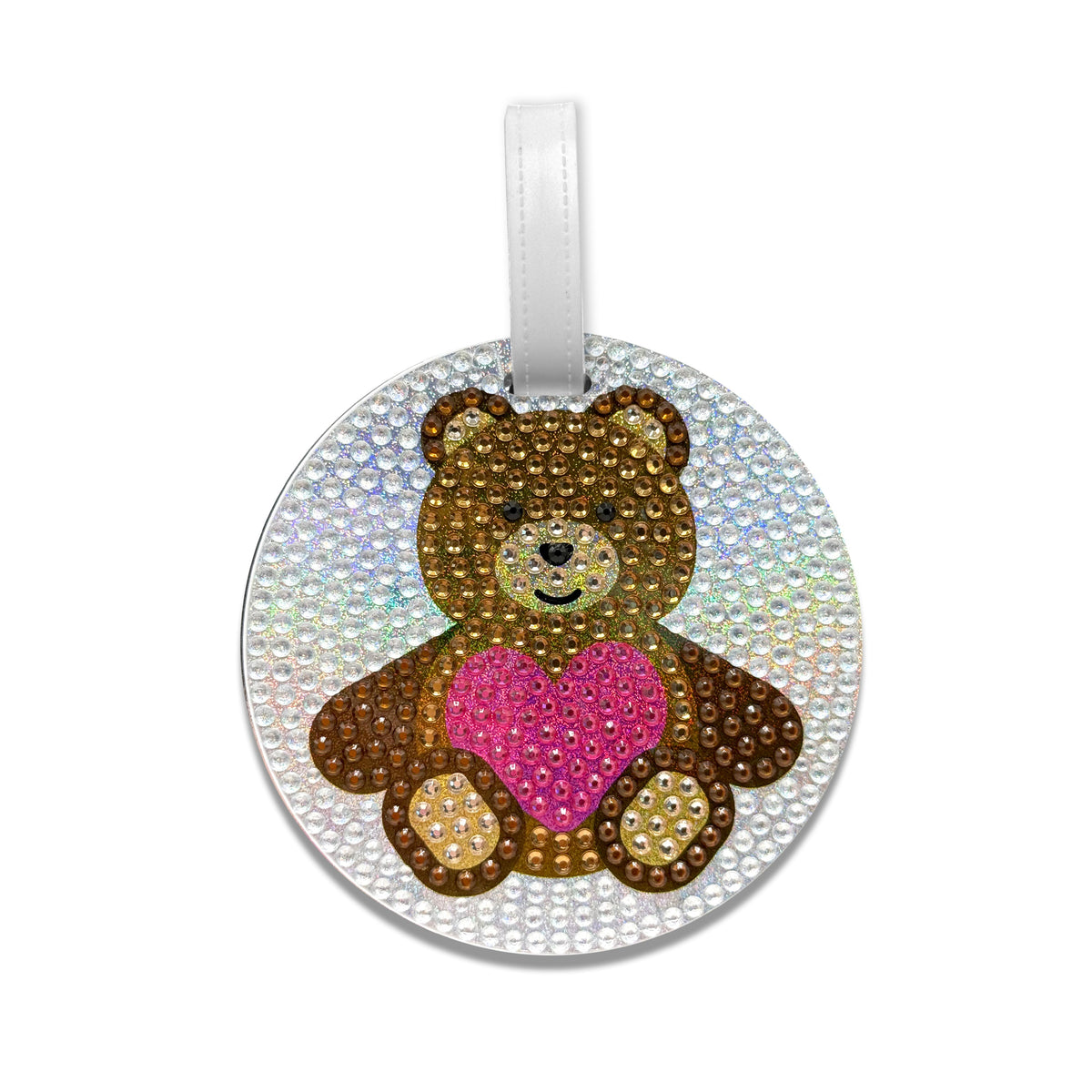 Sparkly teddy bear luggage tag with rhinestones featuring brown bear holding pink heart on white iridescent background with silver hanging loop