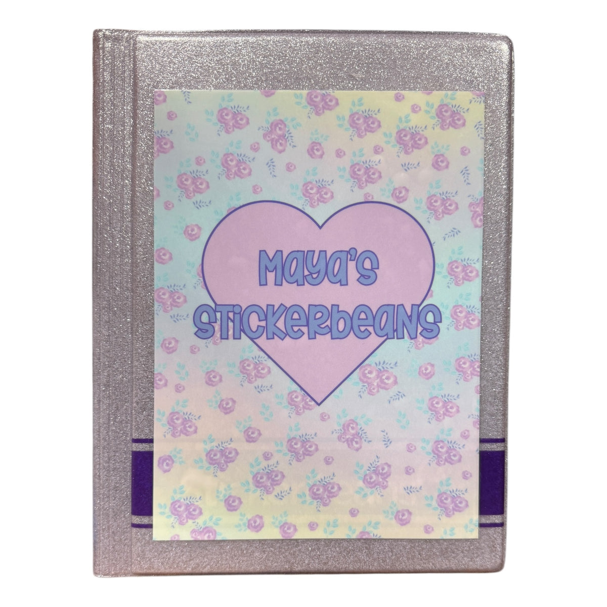 Blushing Blossoms Stickerbean Book with sparkly silver frame featuring pastel floral pattern and purple heart design with text Maya's Stickerbeans on cream background