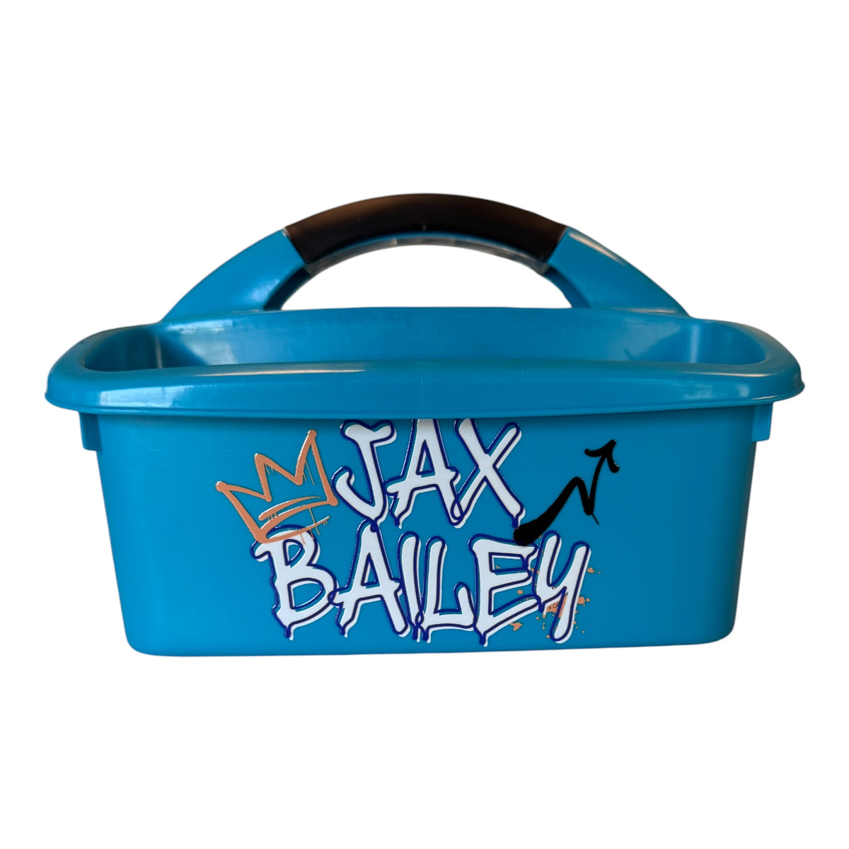 Bright blue shower caddy with graffiti-style JAX BAILEY design, featuring three compartments and curved carry handle