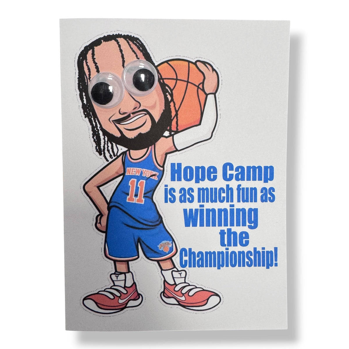 JB Wiggly Eye Card featuring cartoon basketball player in blue New York jersey number 11 with googly eyes holding an orange basketball and text saying Hope Camp is as much fun as winning the Championship