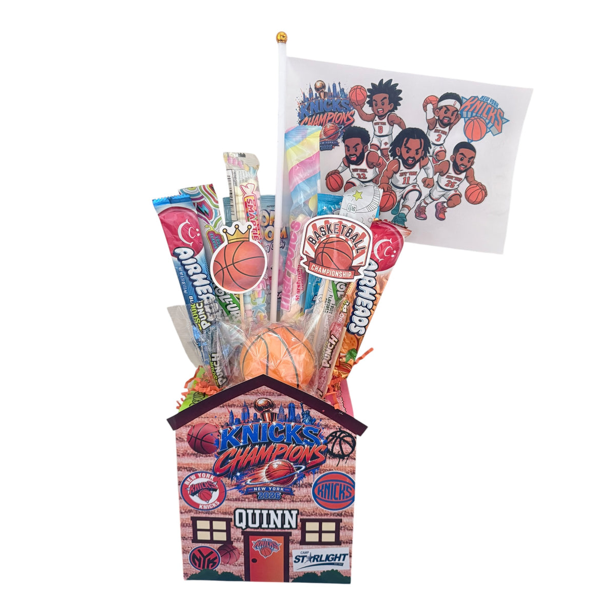 Knicks Courtside Candy Cabin with personalized flag, cartoon basketball players, candy necklaces, lollipops and movie-size candy boxes in orange and blue theme