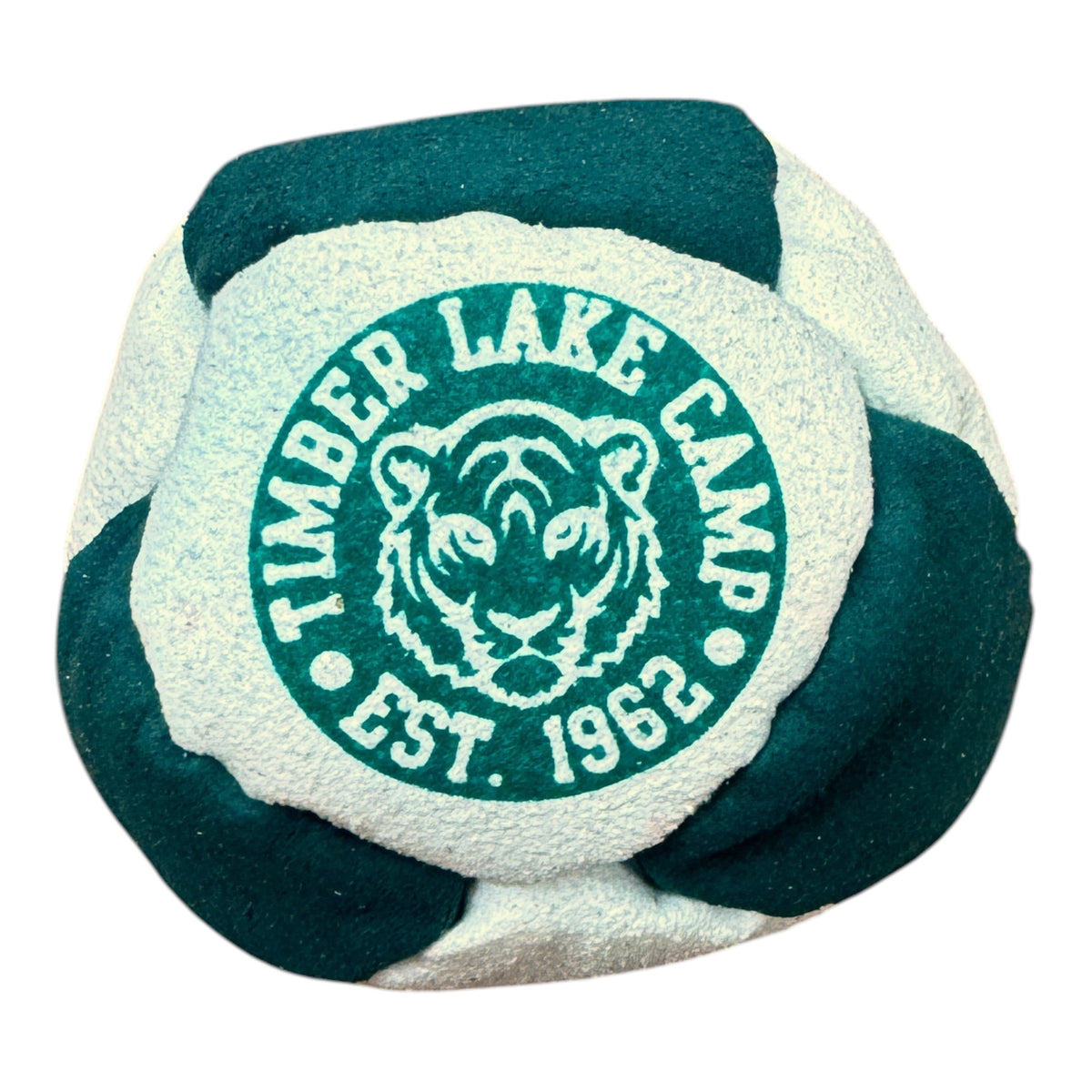 Close-up of Timber Lake Camp hacky sack in green and beige with tiger logo and EST. 1962 text