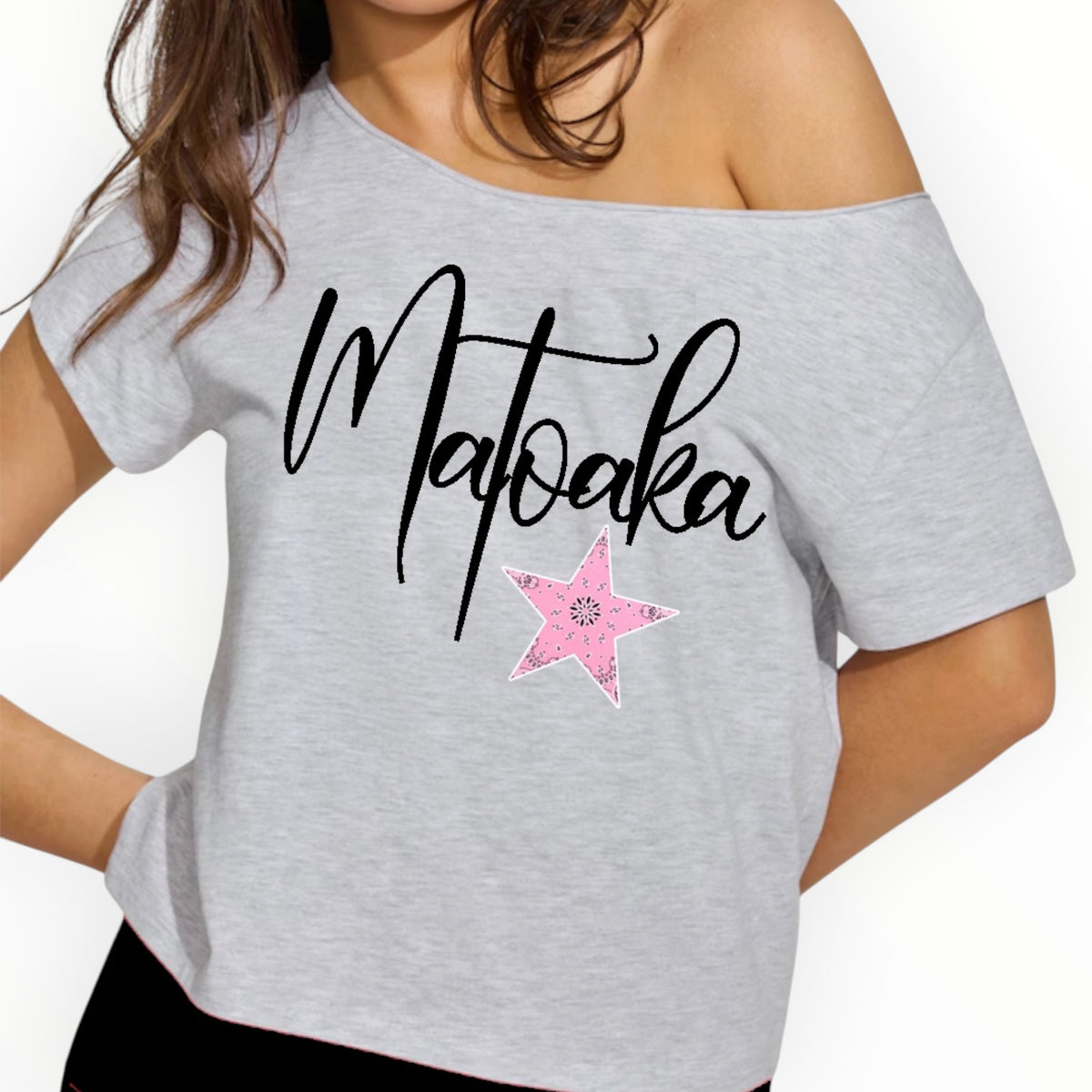 Personalized Matabaka camp tee in heather grey off-shoulder style with black script lettering and pink bandana star