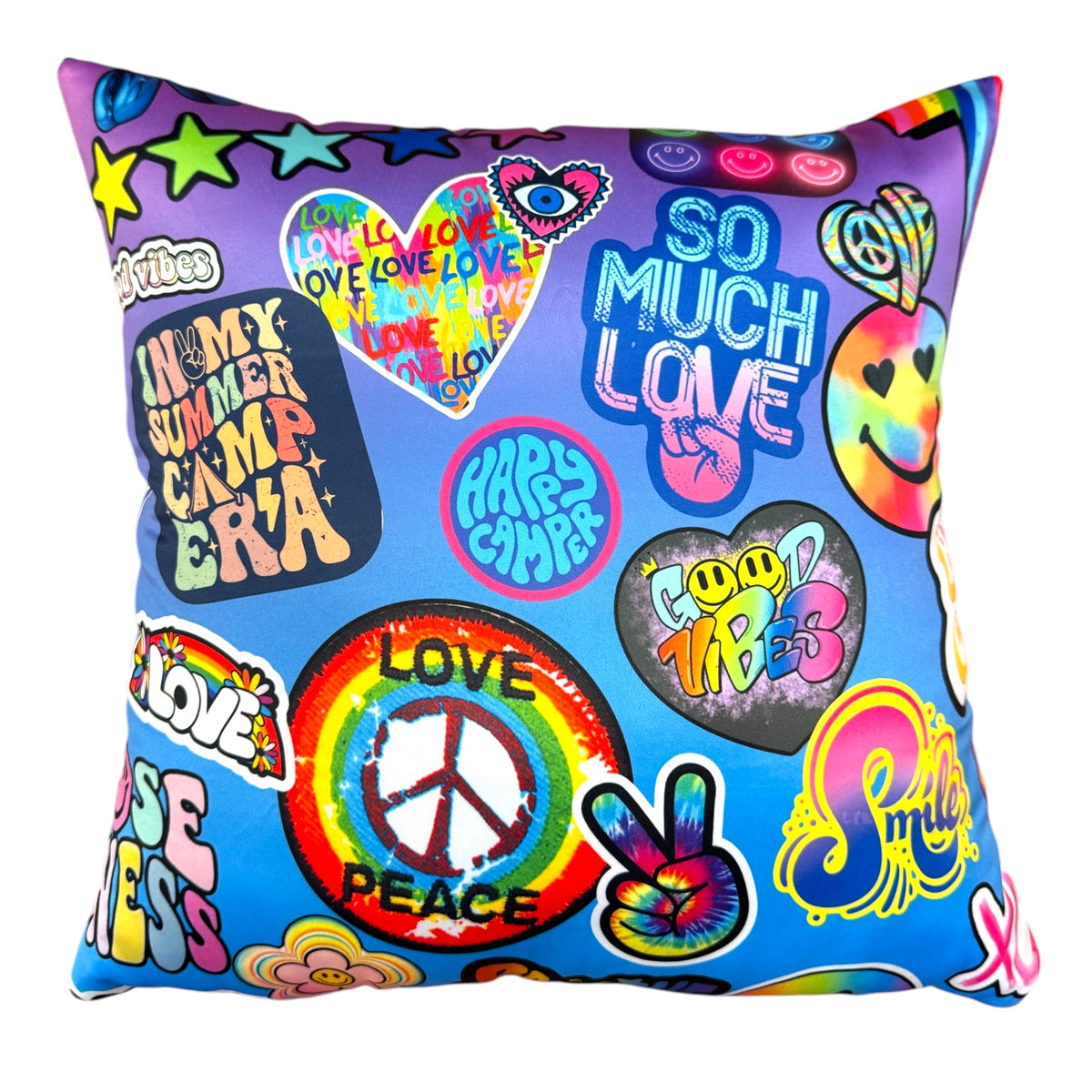 10 for 2 Autograph Pillow with colorful retro graphics including rainbow peace sign, love hearts, happy camper text, smiley faces, good vibes lettering on blue and purple ombre background