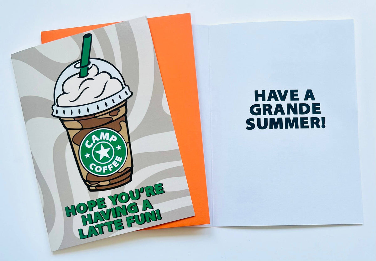 Camp Coffee greeting card with illustrated frappuccino cup topped with whipped cream and green straw, featuring Camp Coffee logo and text reading Hope You're Having a Latte Fun on beige swirl background
