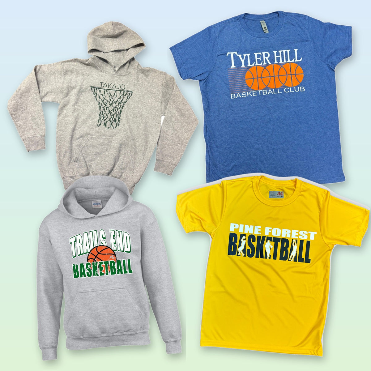 The four-piece basketball camp clothing bundle laid out overhead: two hoodies and two tees, each personalized with a camp name.
