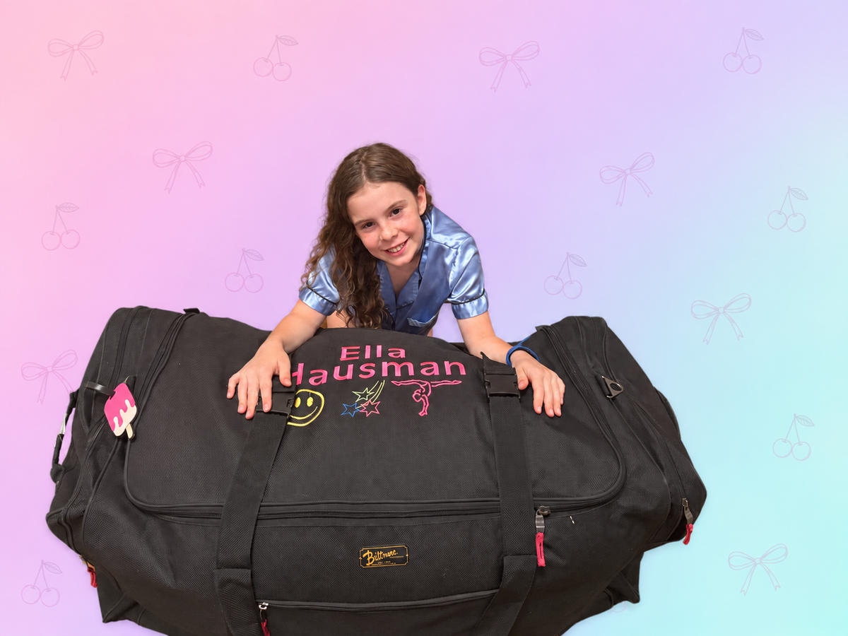 Girl leaning over her personalized camp trunk