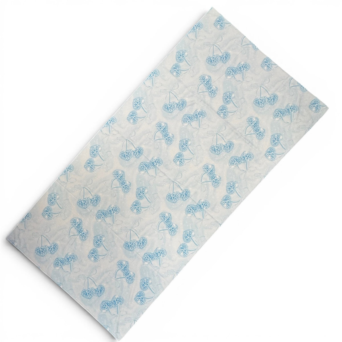 Denim and Diamonds quick-dry camp towel with soft blue floral pattern on light background, folded to show design detail