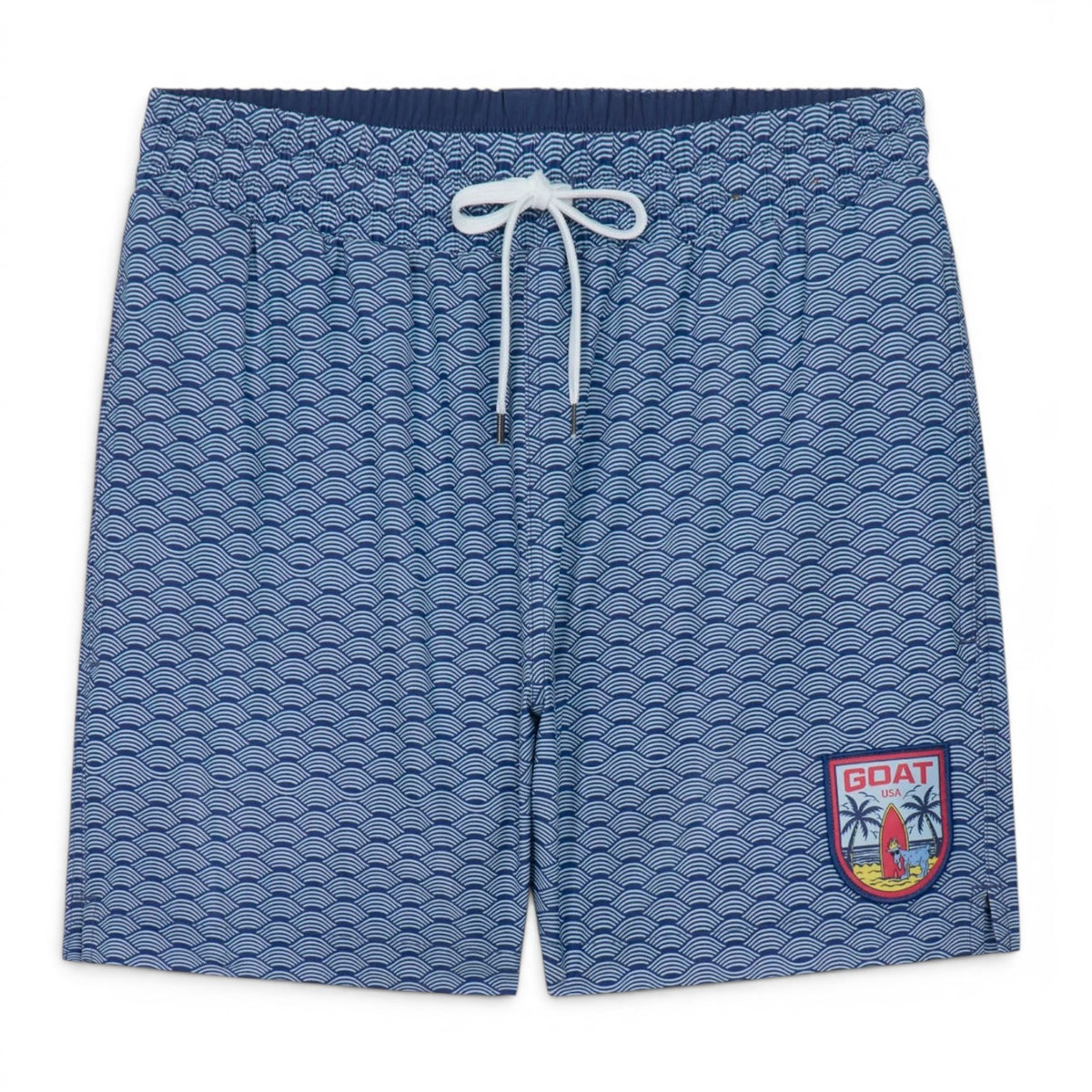 GOAT Wave bathing suit trunks in navy blue with white Japanese wave pattern, white drawstring waist, and red GOAT USA patch with palm trees on right leg