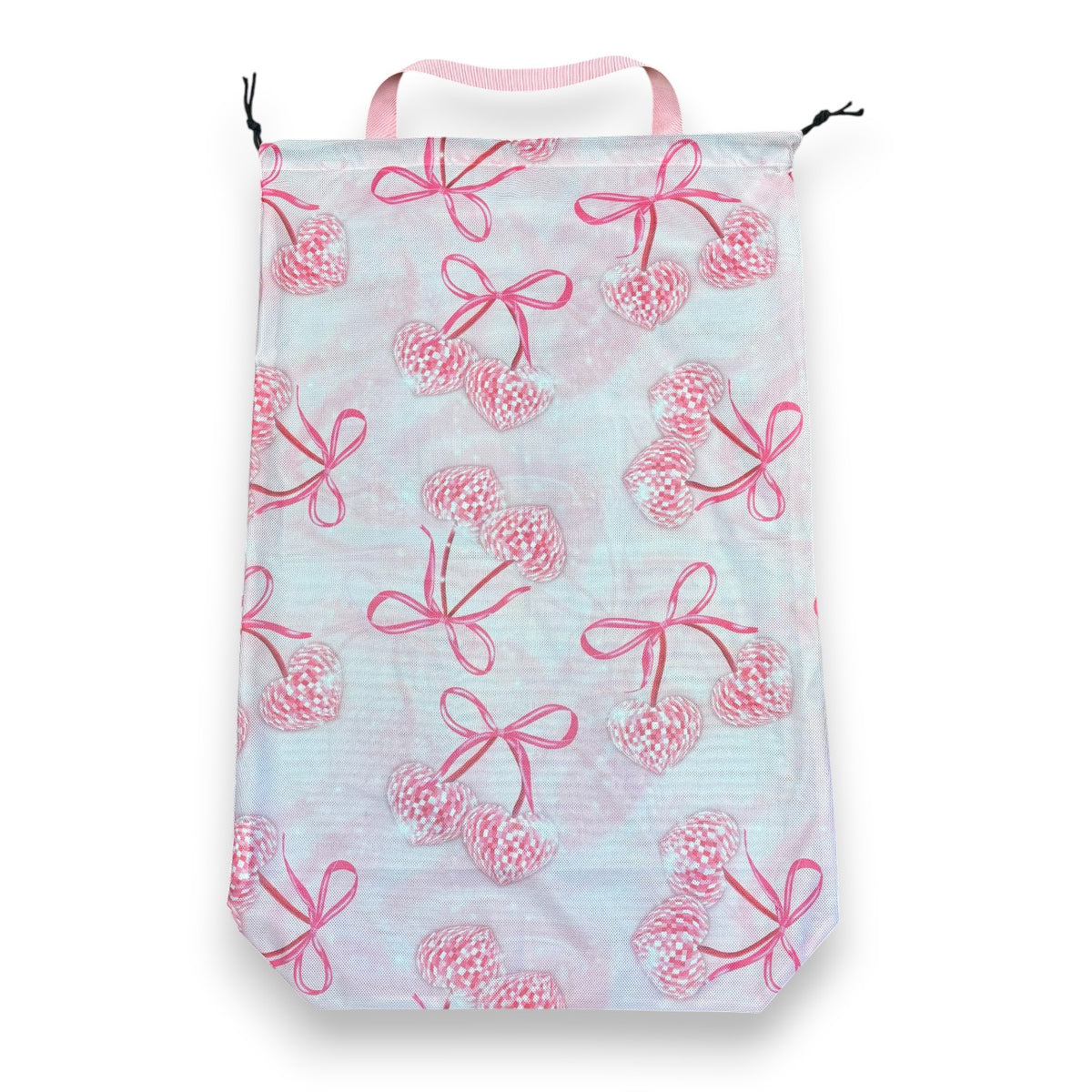 Mesh laundry bag in a pink bow and cherry-heart print on a light background