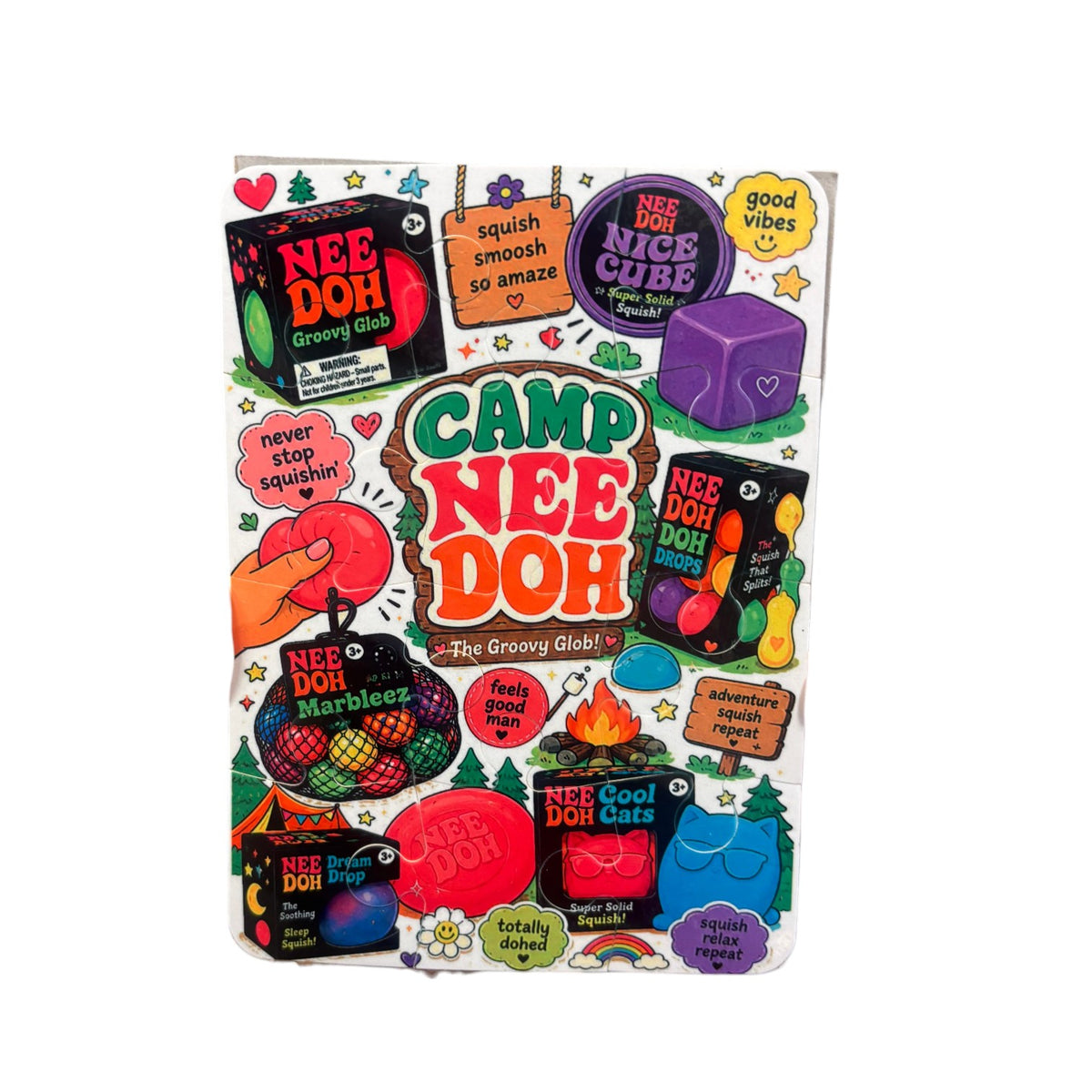 Camp NeeDoh Puzzle Card featuring colorful squishy NeeDoh characters, product packaging, and 12-piece puzzle with wooden sign design and camp-themed illustrations
