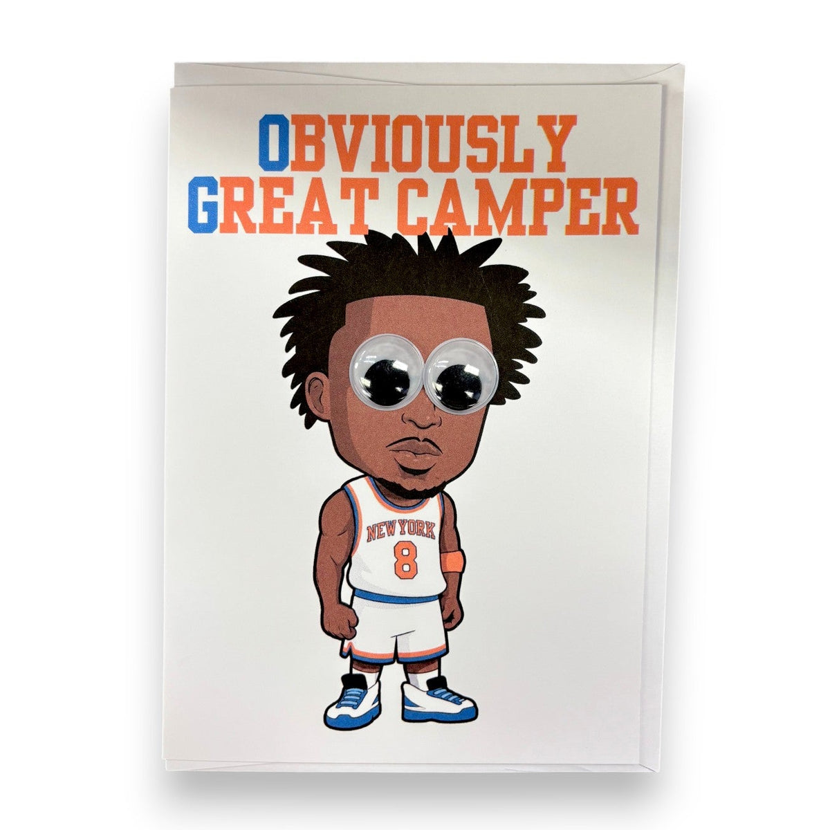 OG Wiggly Eye Card featuring basketball player caricature in blue New York jersey number 8 with oversized googly eyes and text Obviously Great Camper