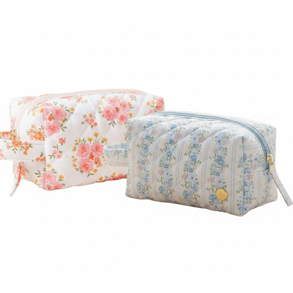 Two quilted cosmetic pouches, one in pink and orange floral and one in blue striped floral